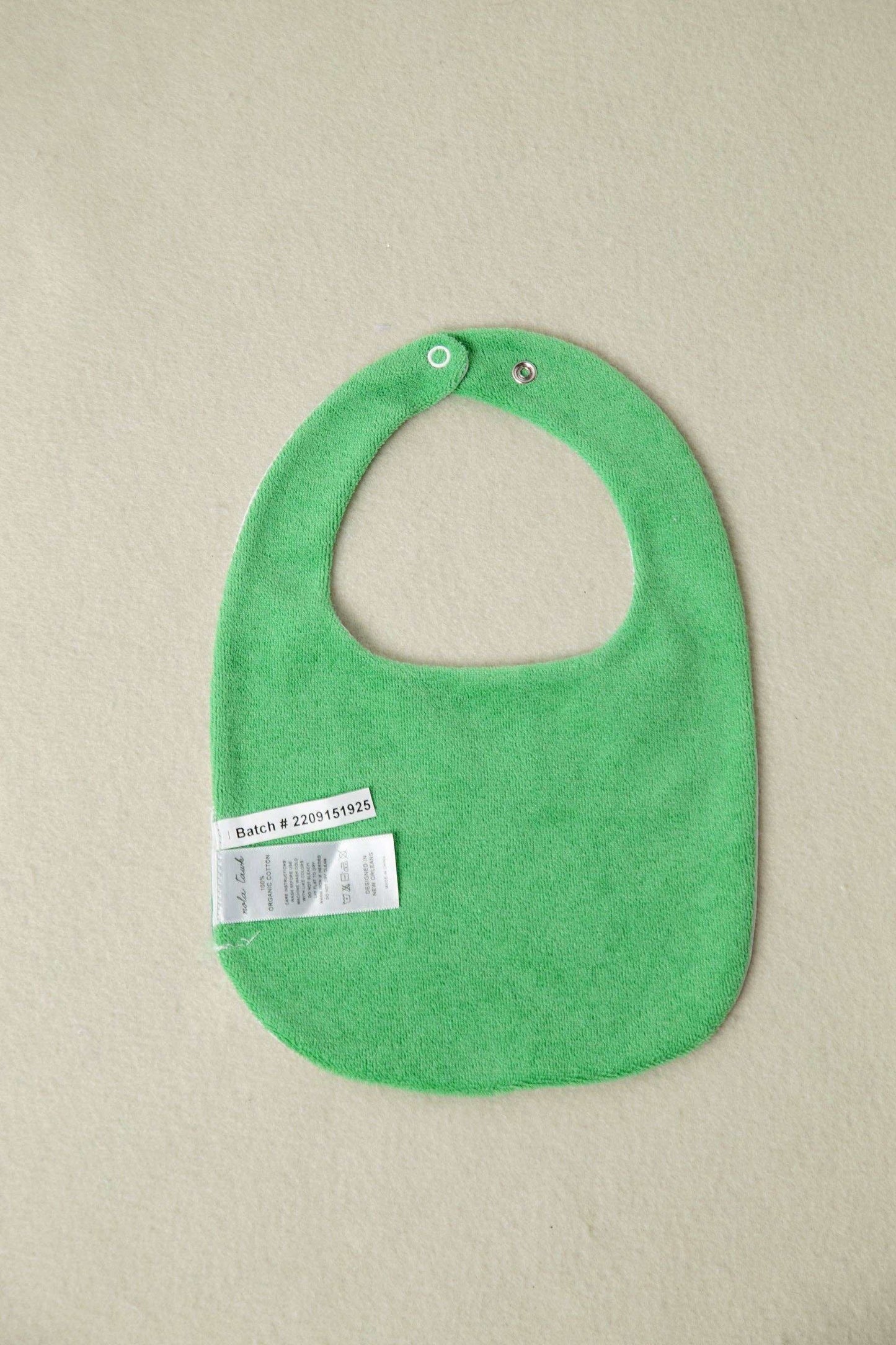 My First Beignet organic cotton baby bib, back view