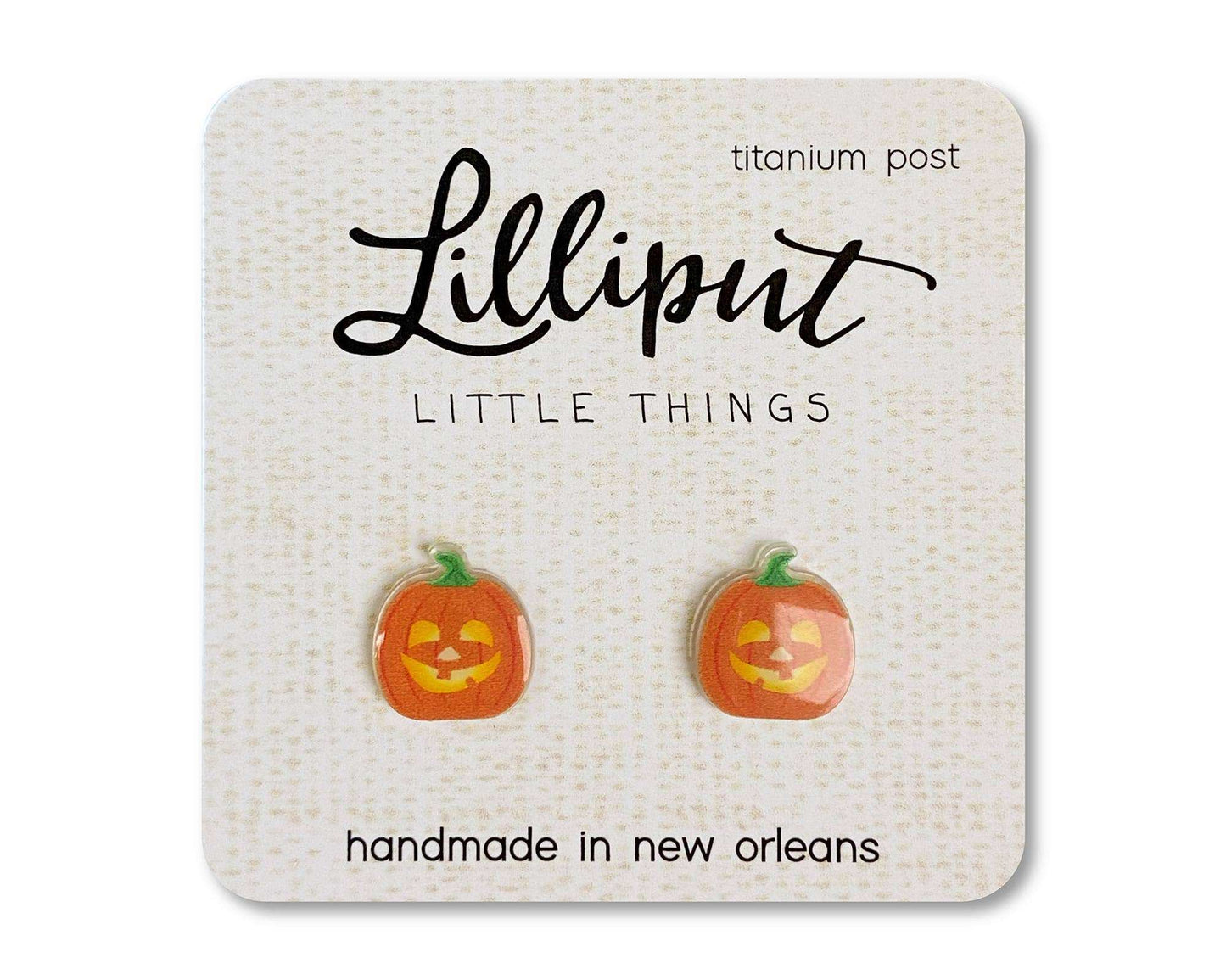 Jack O' Lantern earrings with hypoallergenic titanium posts, waterproof UV ink design on clear acrylic, handmade in New Orleans.
