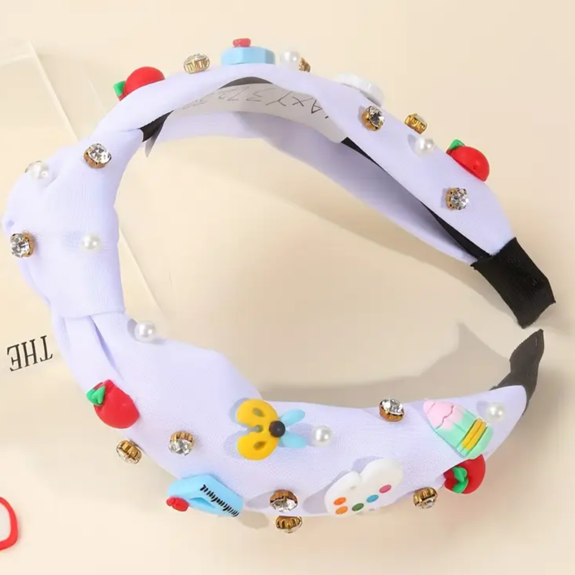 Decorative headband with colorful designs on a beige background