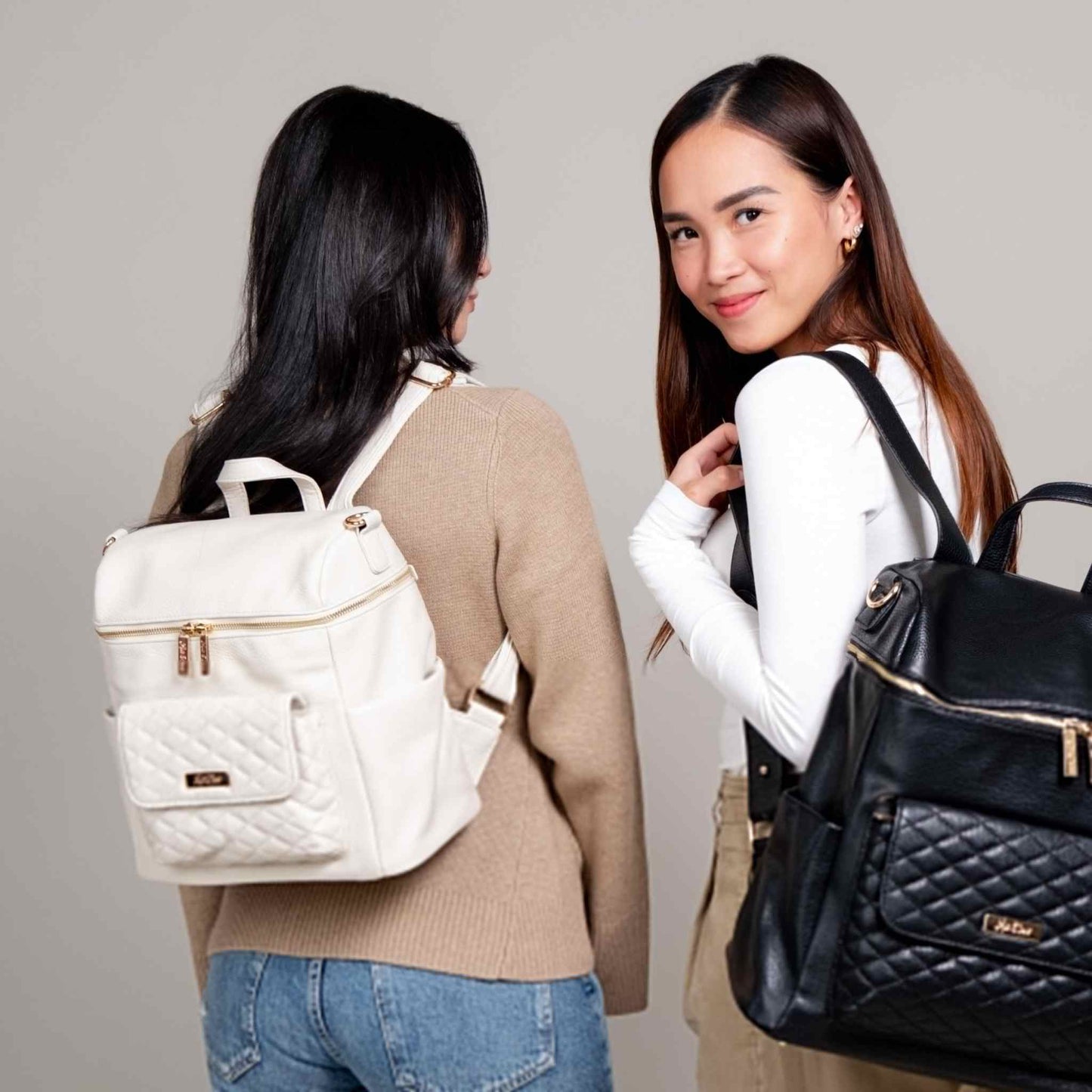 Petit Monaco Diaper Bag in Pearl White worn by model, elegant mini backpack style.
