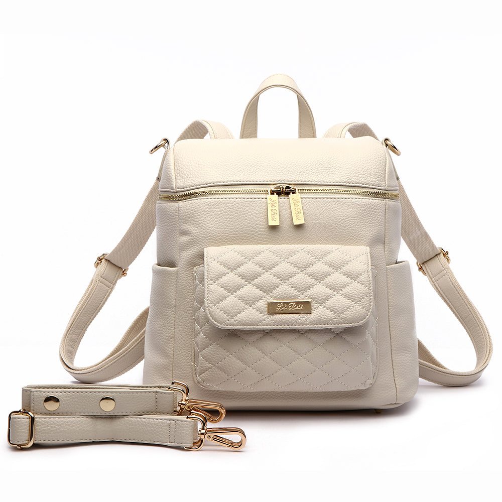 Petit Monaco Diaper Bag in pearl white vegan leather with convertible backpack and crossbody options.