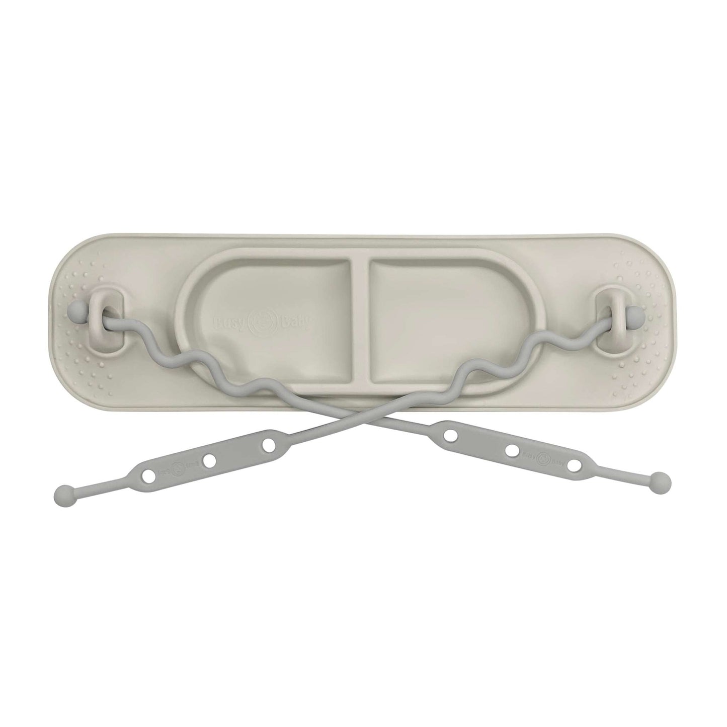 Busy Baby Mini Mat in tan with toy straps and suction cups for secure placement on smooth surfaces, designed for travel and small trays.