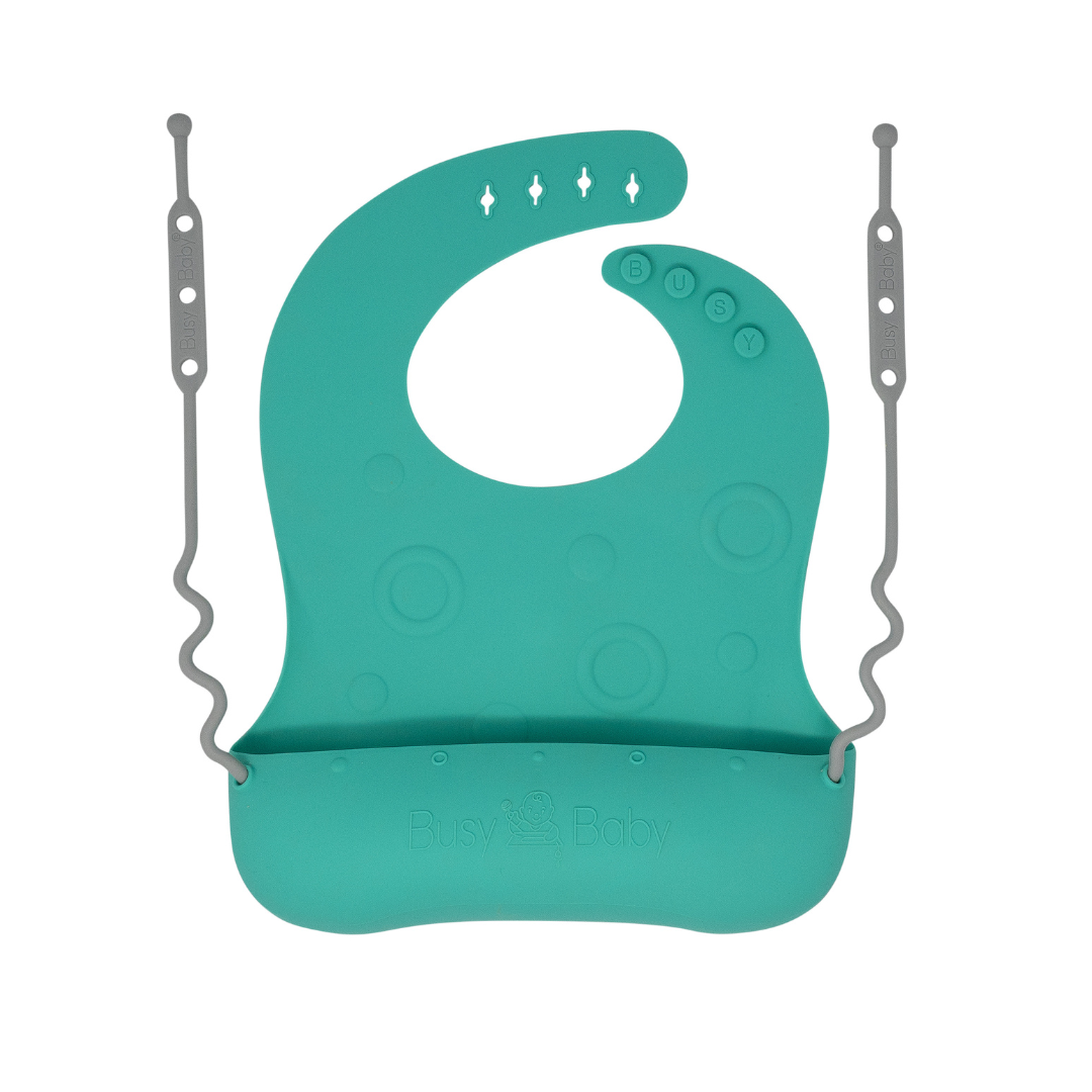 Spearmint silicone Travel Tether Bib with oversized pouch and utensil tethers for easy baby feeding and mess containment
