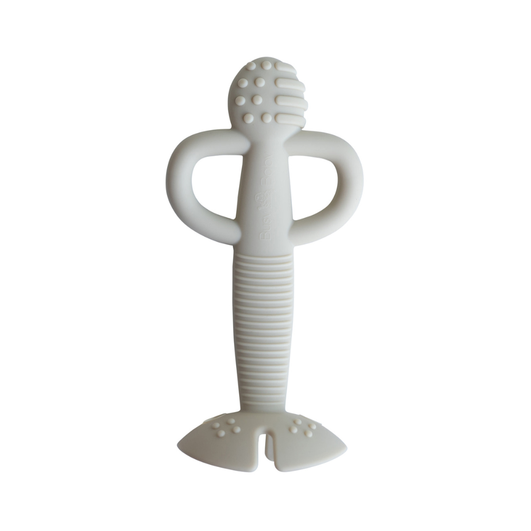 Tan 2-in-1 teether and training spoon made of food-grade silicone with textured grip handle for babies