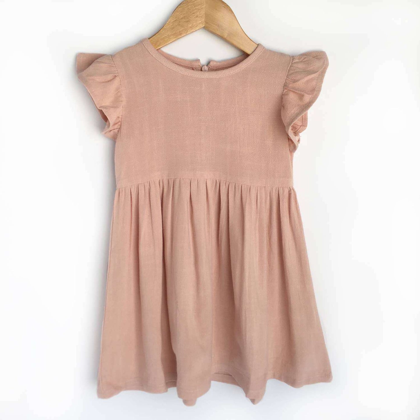 Pink linen dress with flutter sleeves and back zipper.