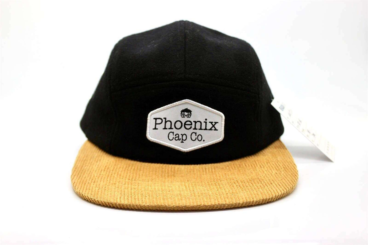 Black wool and tan corduroy hat with leather logo patch, adjustable snap closure called "Stay Golden".