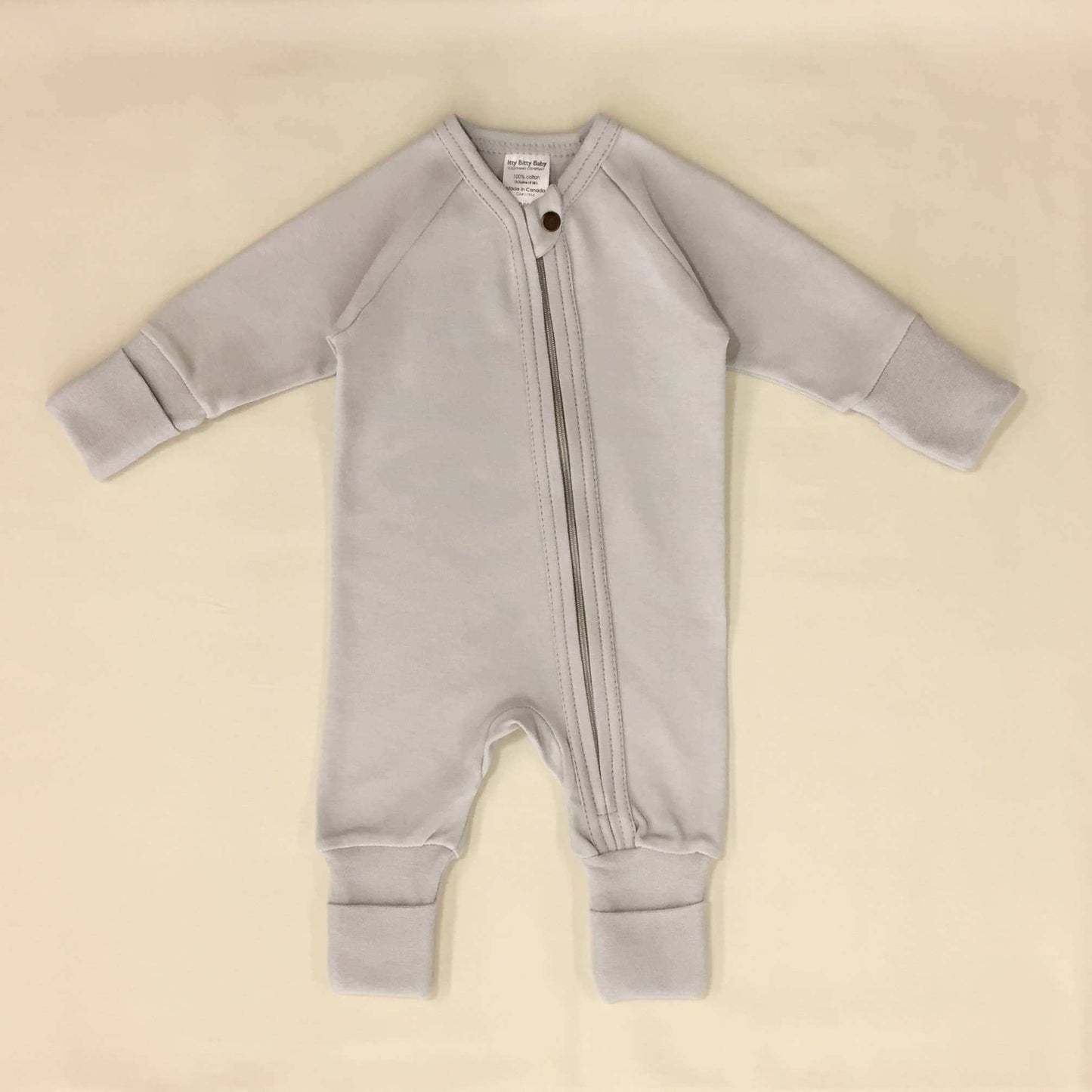Minimalist zip sleep and play suit in granite stone color with YKK zipper and fold-over cuffs.
