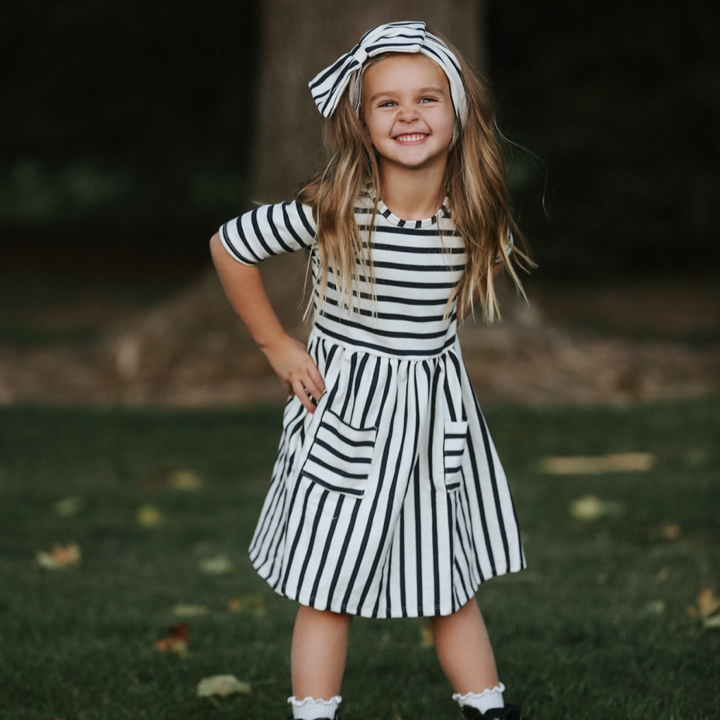 Nora Navy Stripe Twirl Dress with elbow-length sleeves and square pockets.