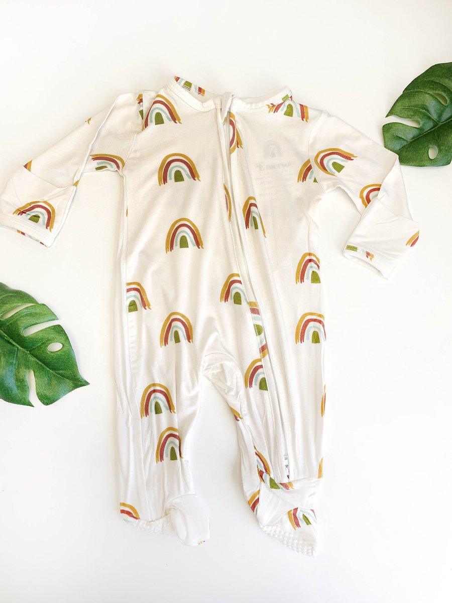 Rainbow bamboo footed romper pajama with rainbow print and two-way zipper on soft bamboo fabric.