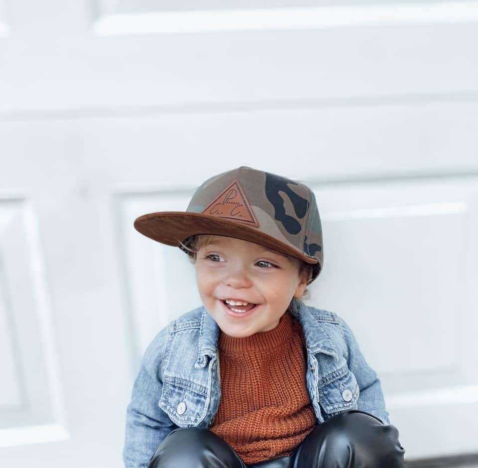 Child wearing Operation Phoenix Cap by Phoenix Cap Co with camo pattern and brown bill.