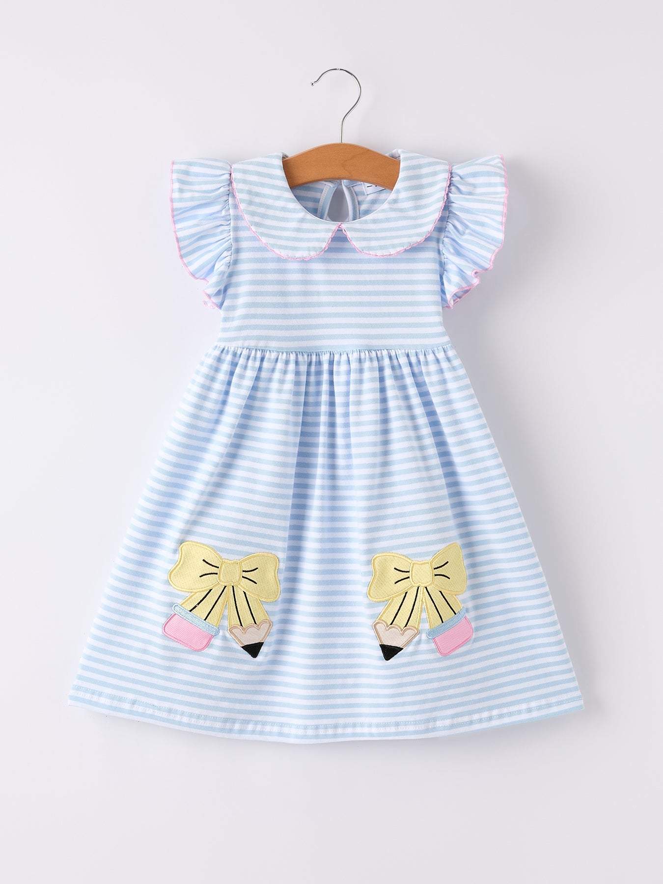 Pencil appliqué bow dress detail