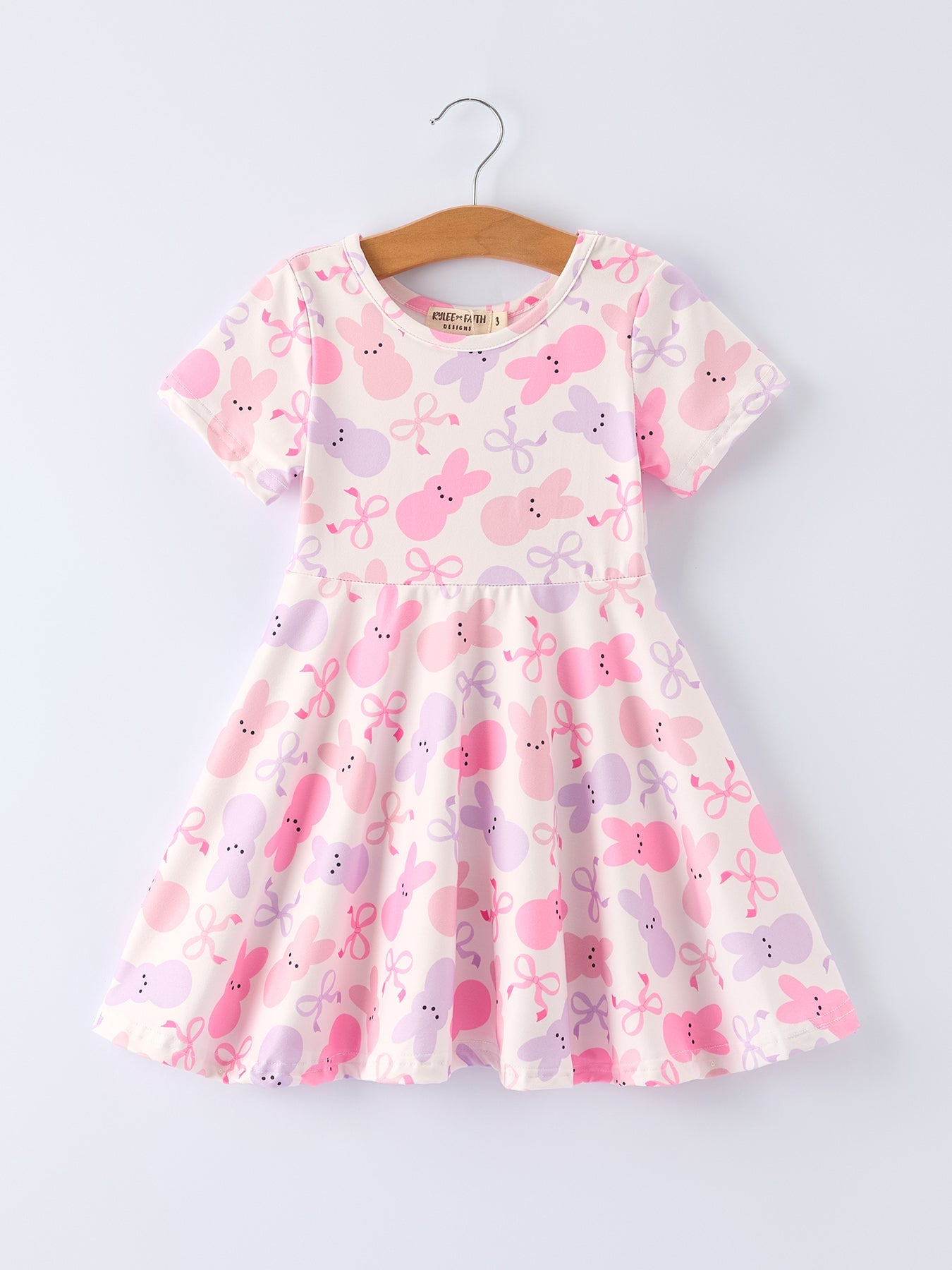 Children's dress with pink and purple floral pattern on a white background