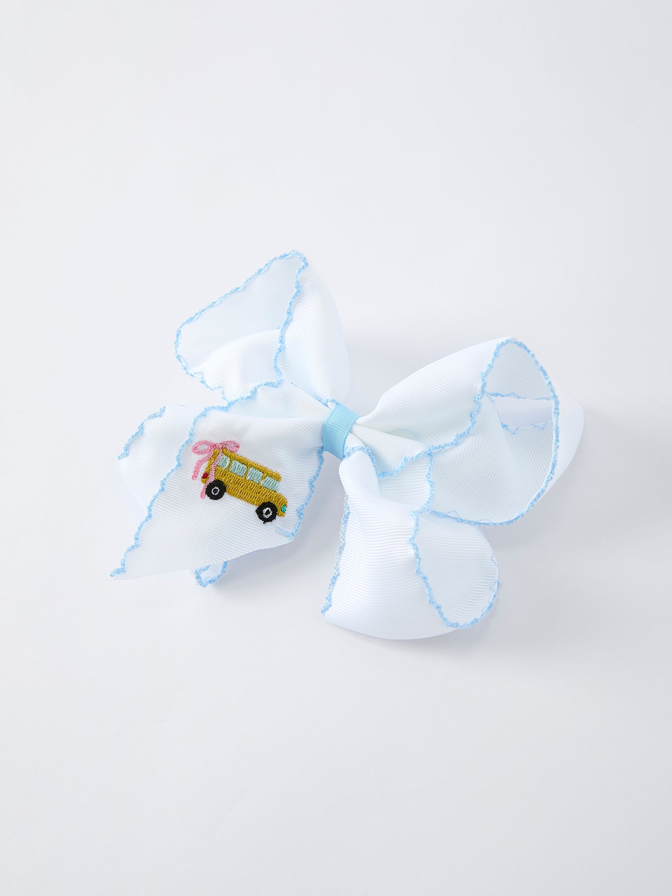 Close-up of truck appliqué detail on girls hairpin