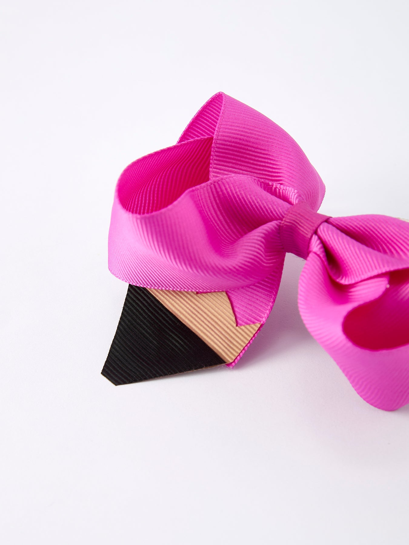Close-up of pencil bow appliqué detail on hair clip