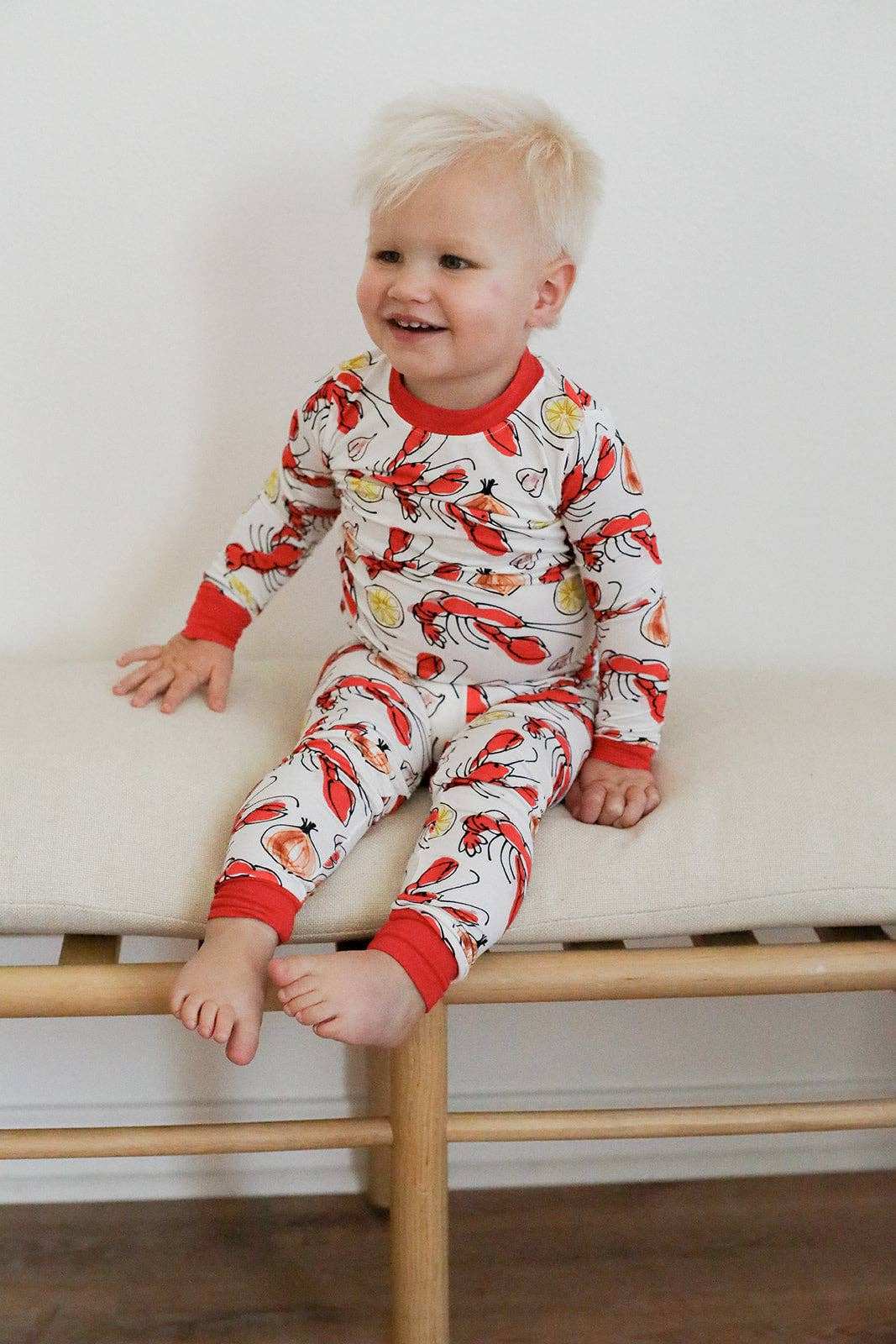 child wearing crawfish pattern pajamas