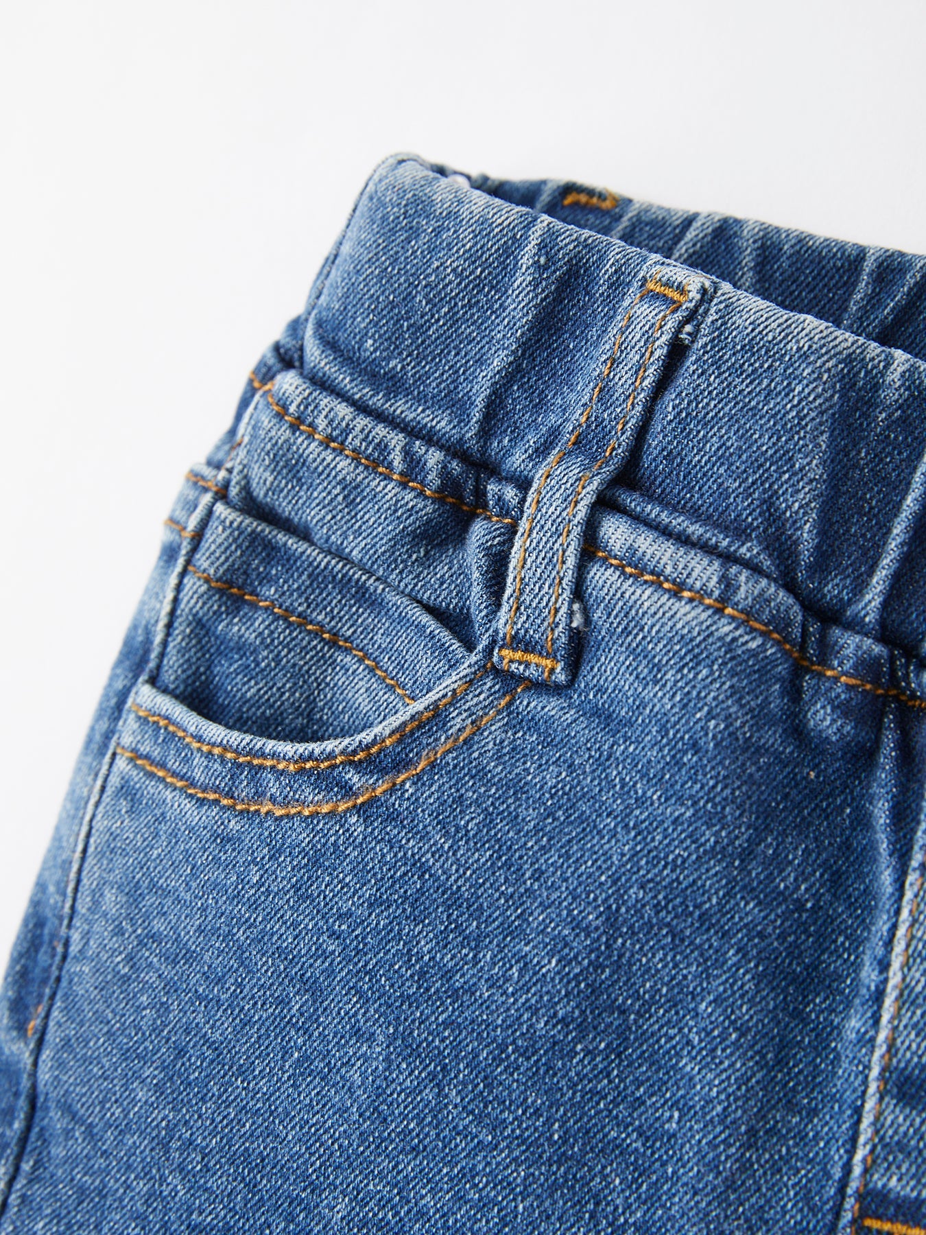 Girls blue denim bell pants detail view