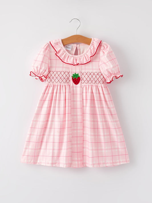 Pink checkered dress with strawberry design on a hanger against a white background