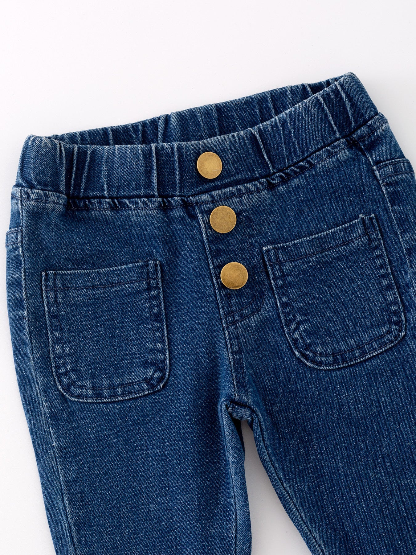 Deep blue bell-bottom denim jeans detail view