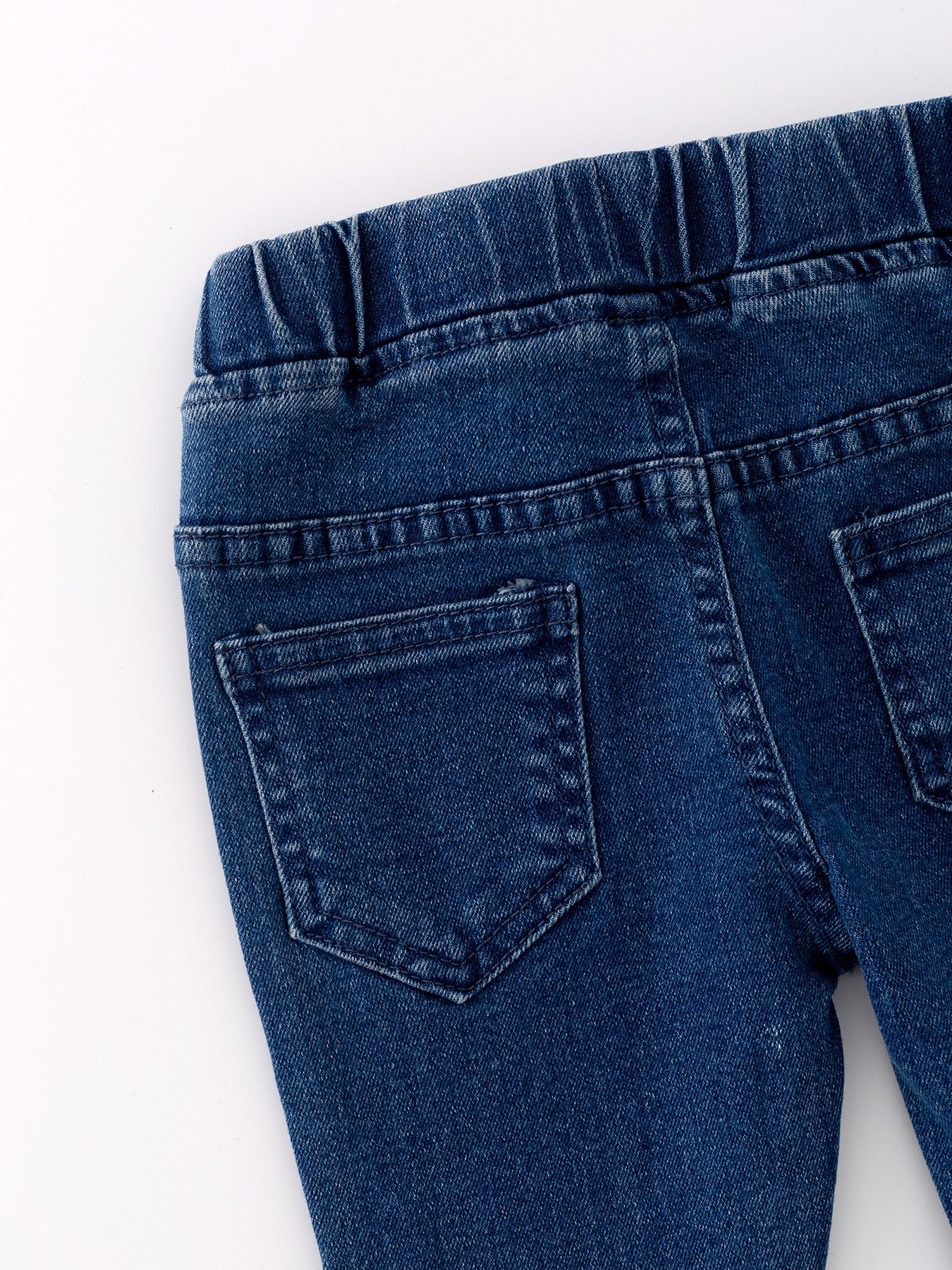 Deep blue spray dye denim fabric close-up