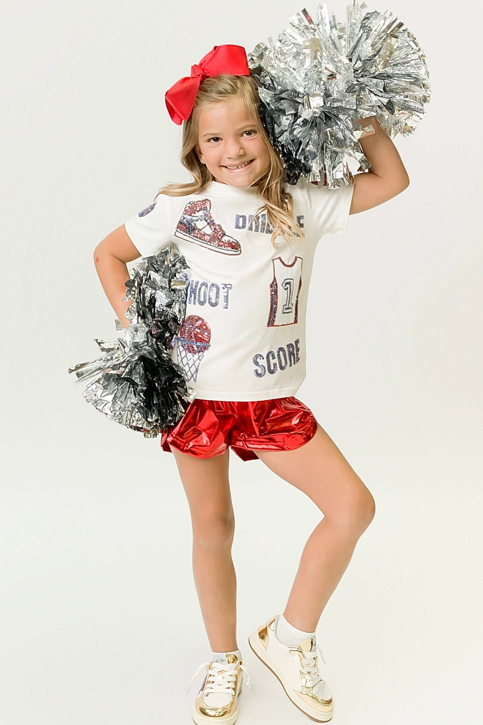 Red and Light Blue Basketball Shirt worn by smiling child with pom poms and red bow
