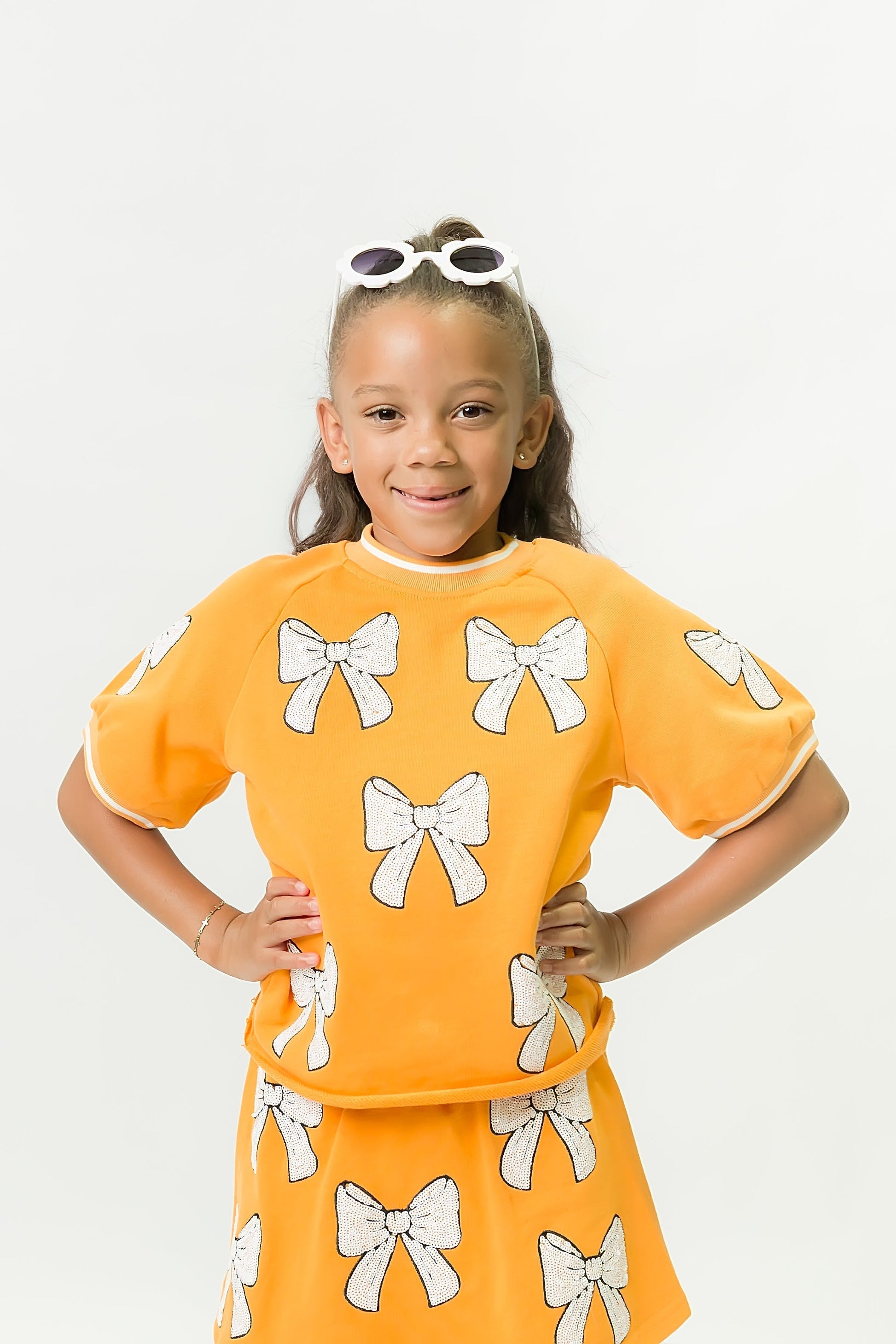 Orange and White Bows Top for kids with playful bow designs and vibrant orange color