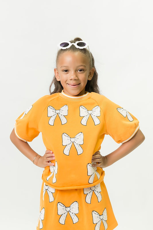 Orange and White Bows Top for kids with playful bow designs and vibrant orange color