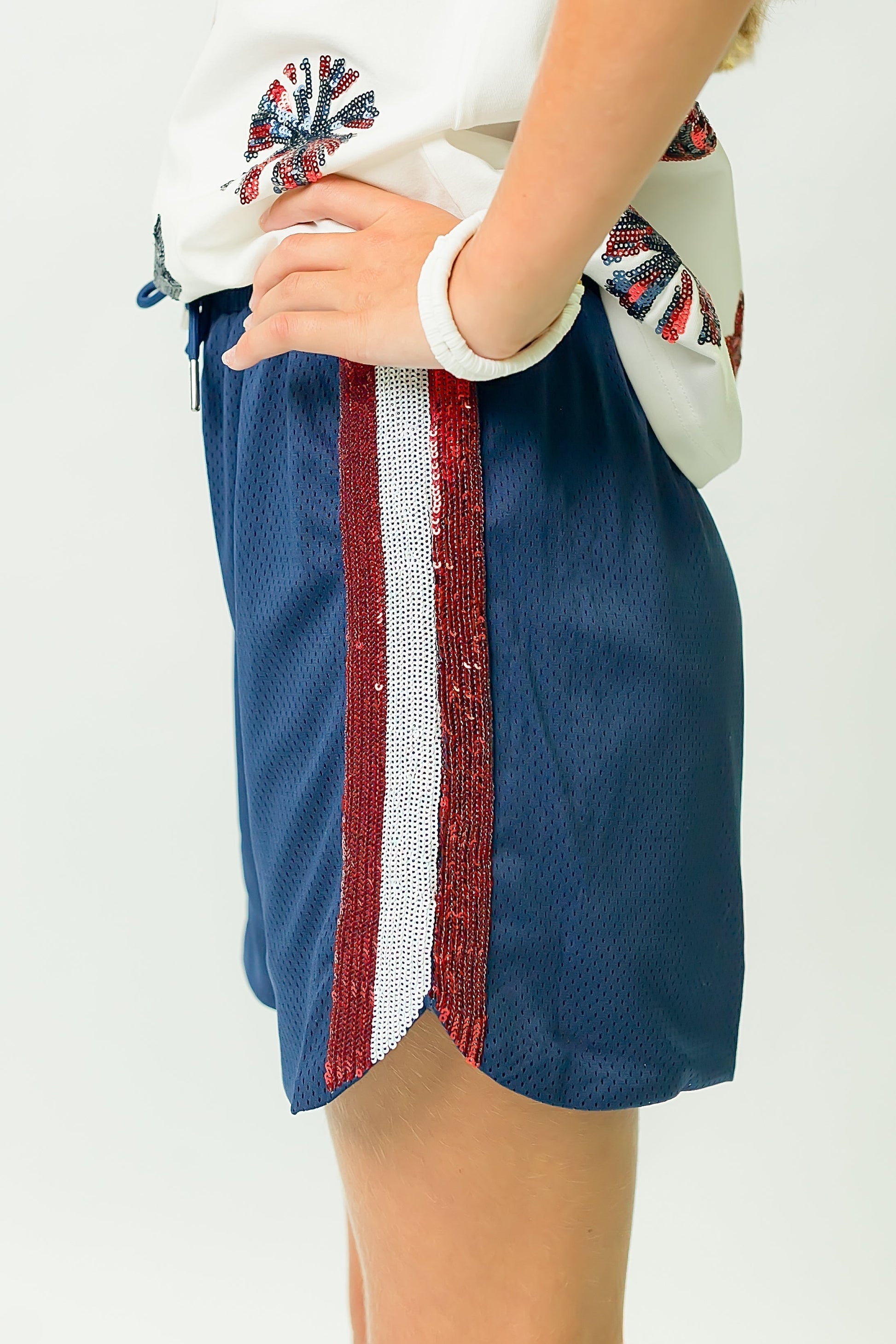 Navy blue shorts with red and white sequin stripes for a sparkling party look