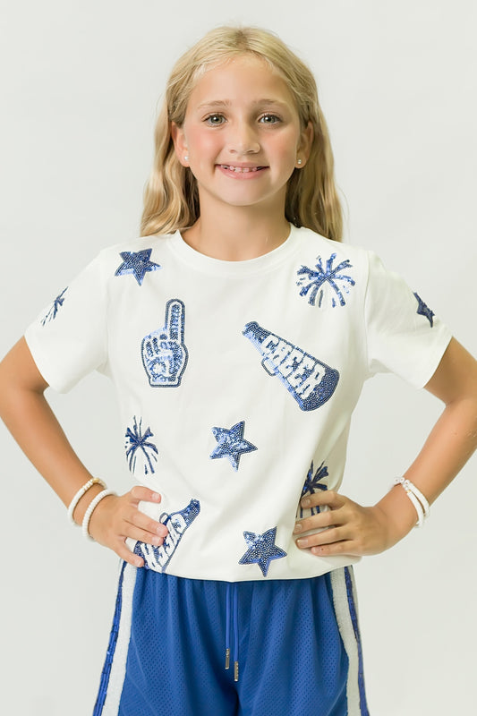 Girl wearing royal blue and white cheer shirt with cheer-themed designs and blue shorts
