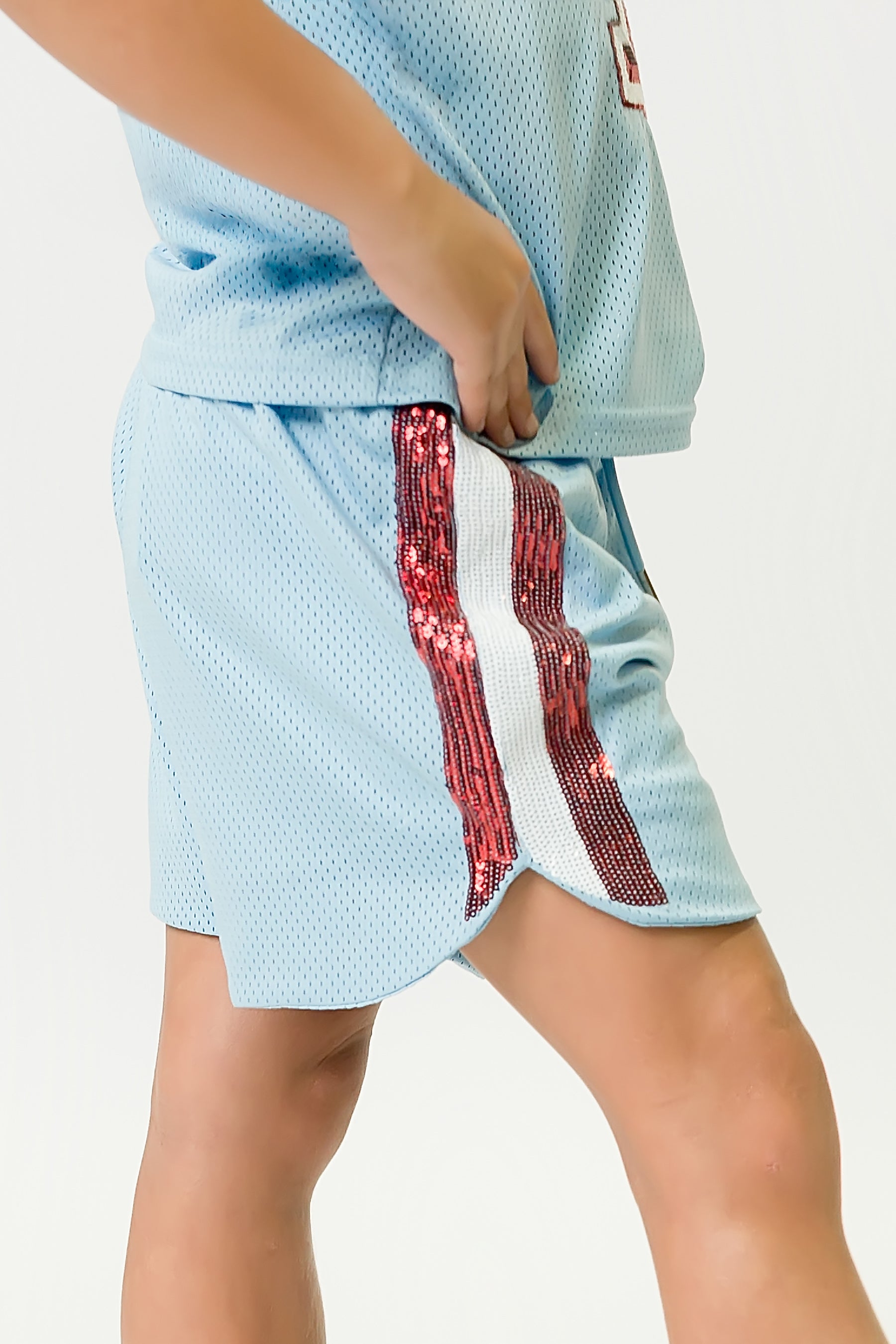 Light blue shorts with red sequin stripes on side