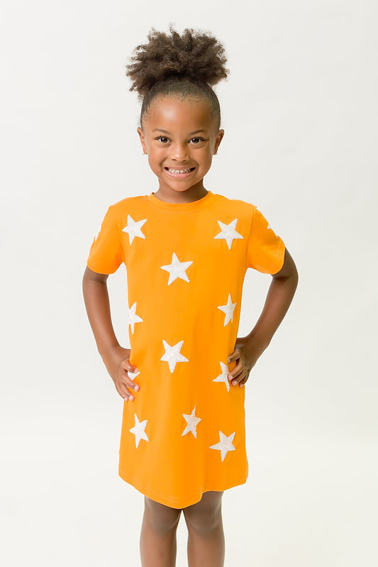 Girl wearing bright orange dress with white star pattern Orange Star Dress