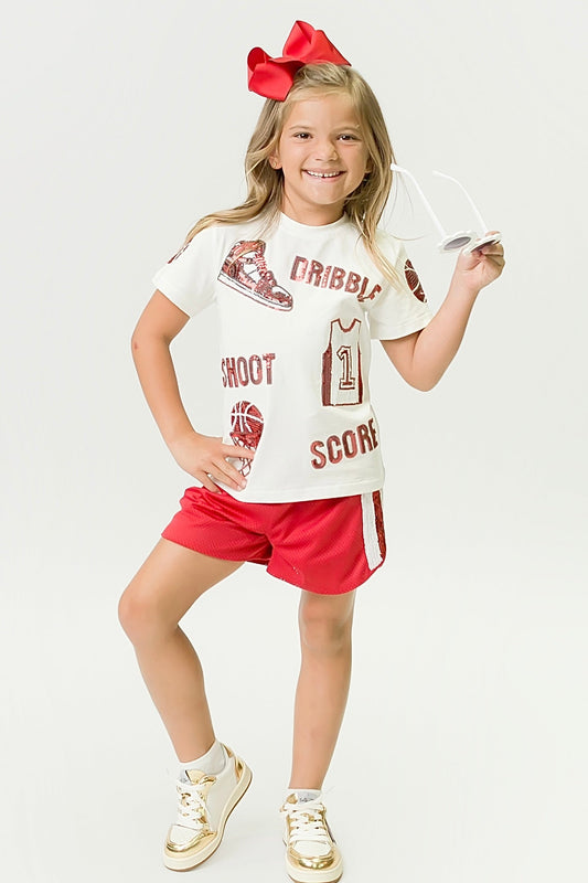 Child wearing red and white basketball shirt and red shorts with a large red bow in her hair