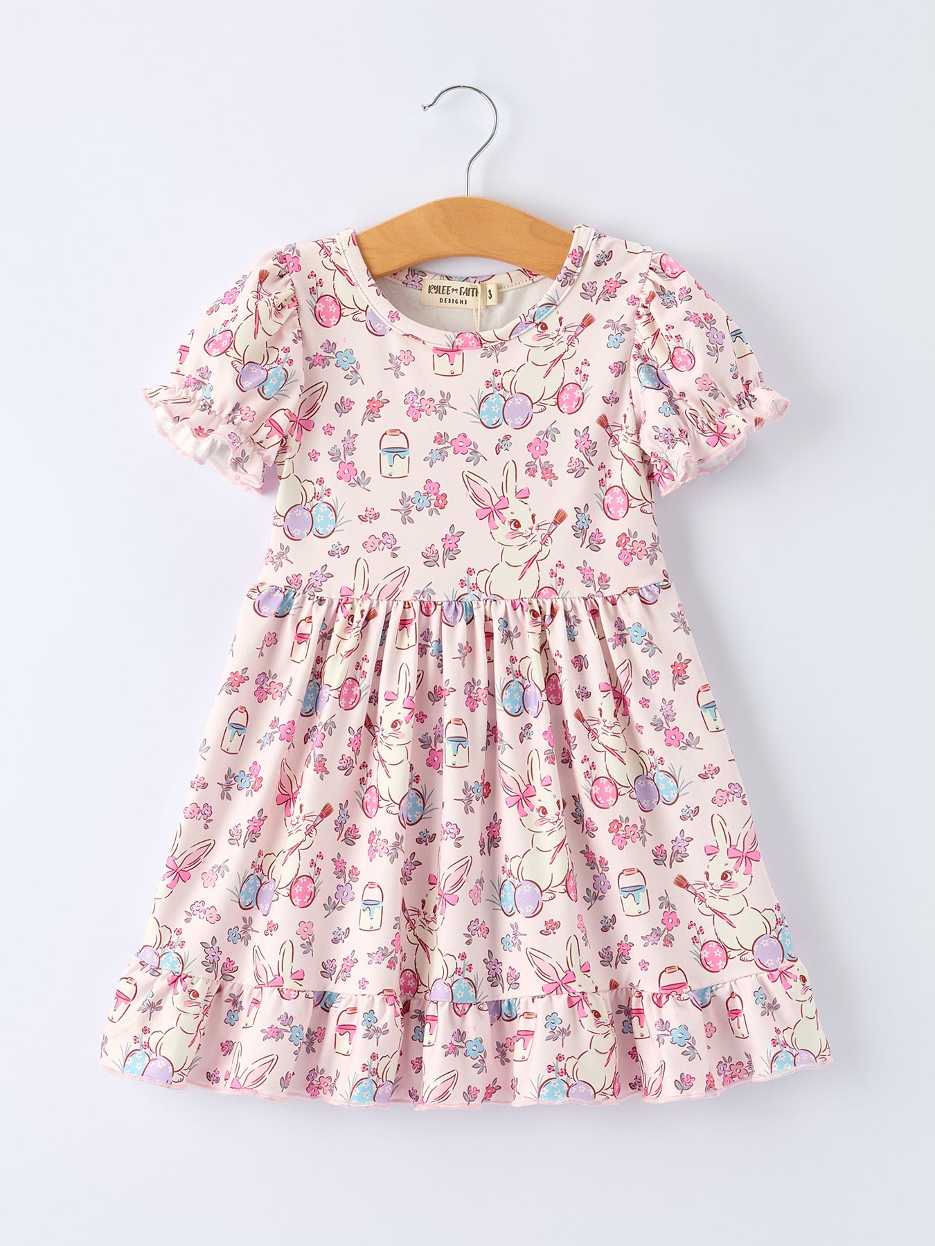 Children's floral dress on a hanger against a white background