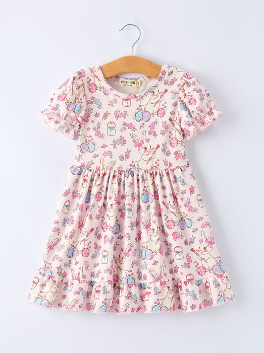 Children's floral dress on a hanger against a white background