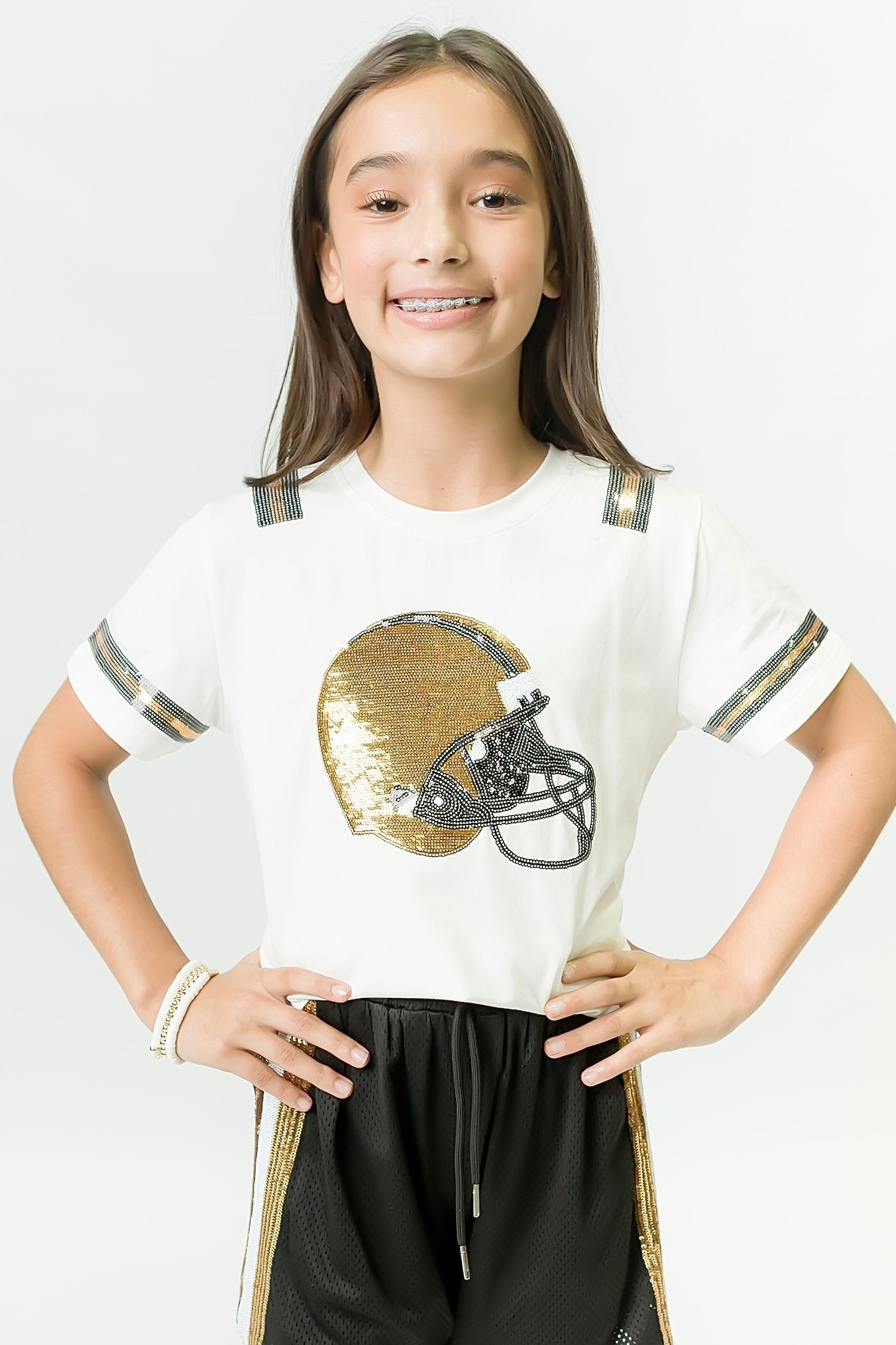 Girl wearing Black and Gold Helmet Shirt with sequin helmet design and striped sleeves