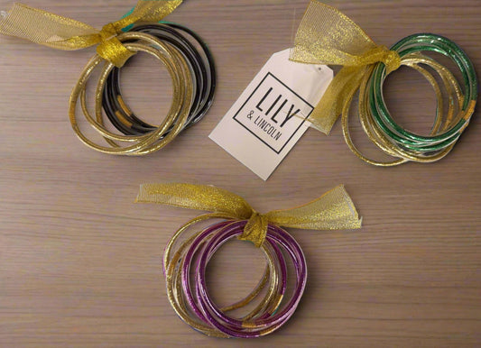 Set of Go Team plastic bracelets in green, purple, black, and gold colors with festive gold ribbons.
