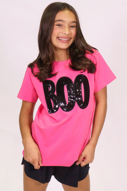 Girl wearing a hot pink Boo shirt with black sequin lettering on Halloween