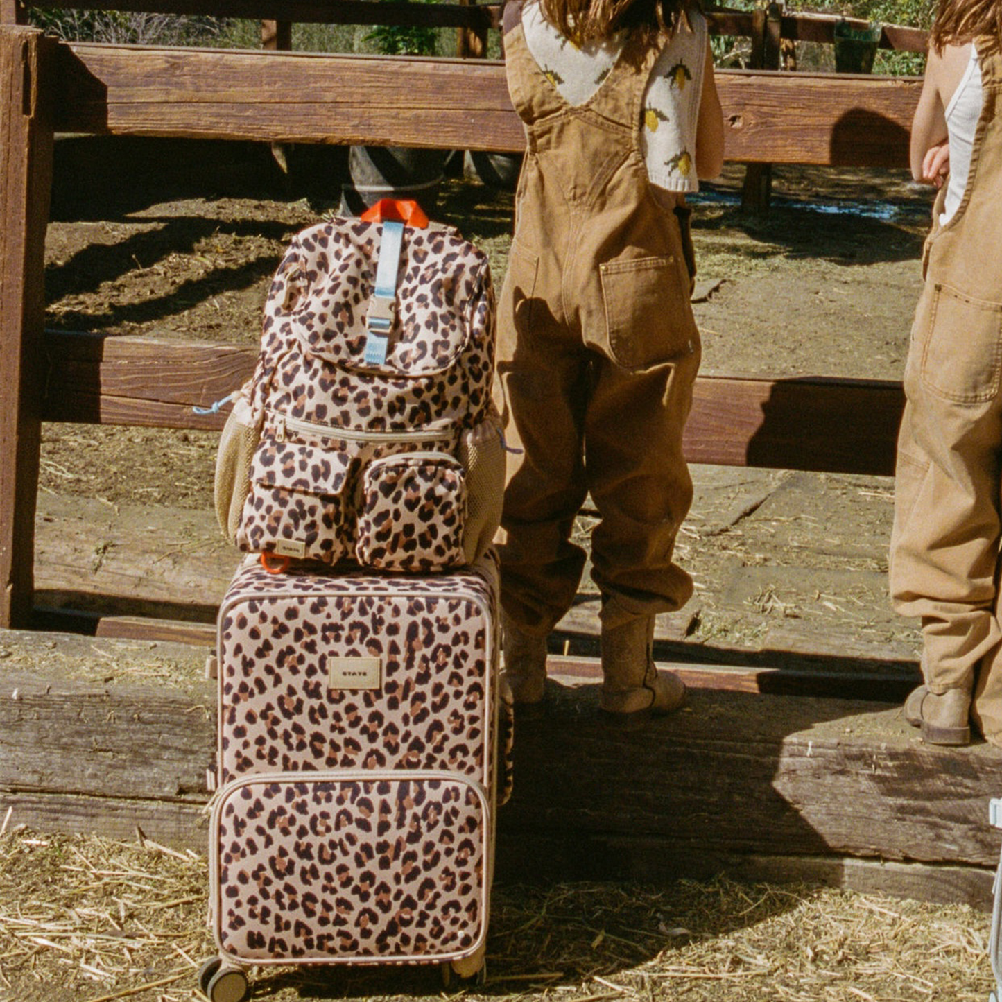 Logan Carry-On Suitcase in Leopard, wheels and handle detail