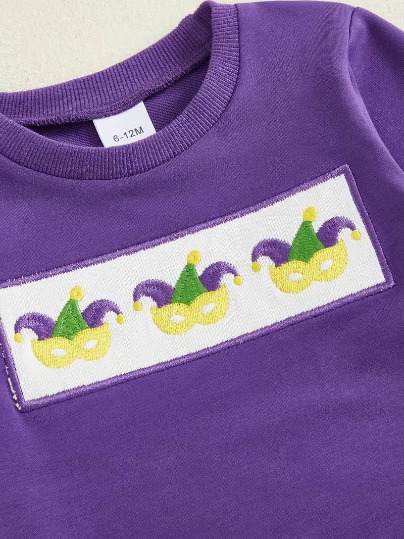 Purple sweatshirt with Mardi Gras mask design on a white label