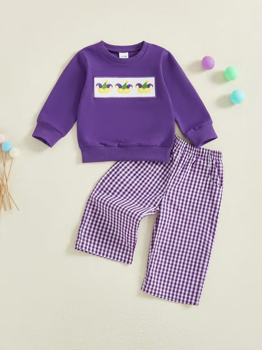 Purple sweatshirt and checkered pants set on a beige background