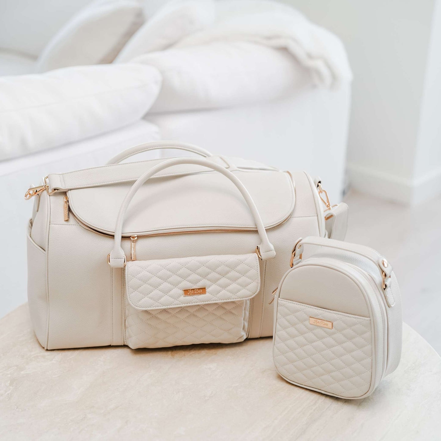 Pearl white Monaco Travel Bag with quilted pocket and smaller accessory pouch.