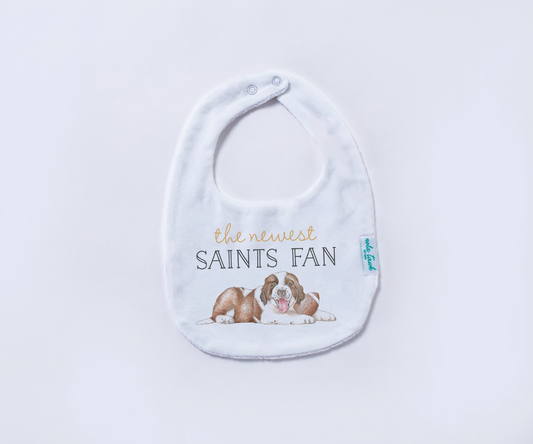 Baby bib with 'the newest Saints fan' text and dog illustration on a white background