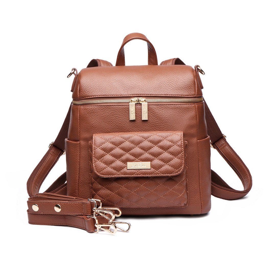 Caramel brown Petit Monaco Diaper Bag made of premium vegan leather with quilted front pocket and convertible straps.
