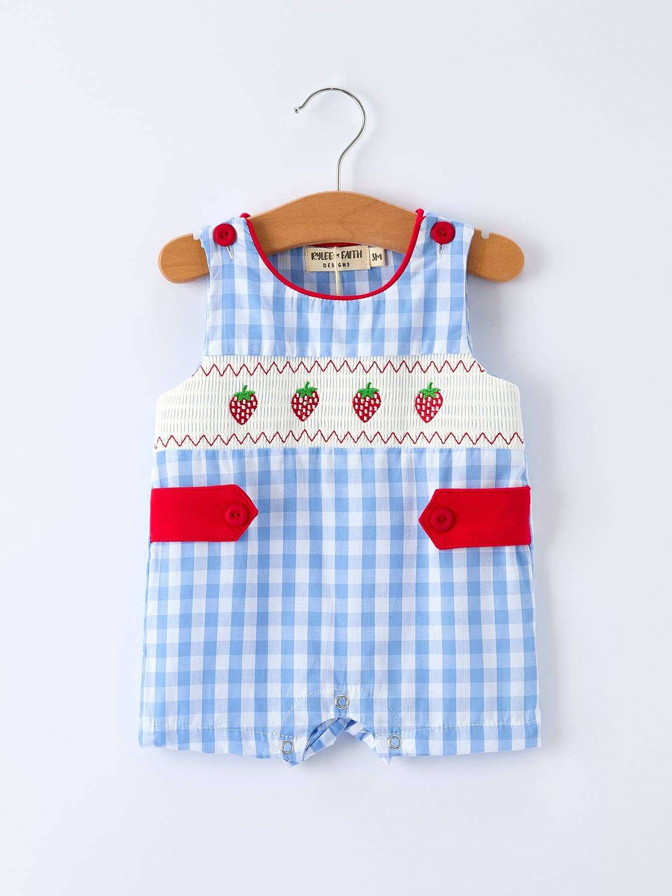 Blue checkered baby romper with red accents on a white background