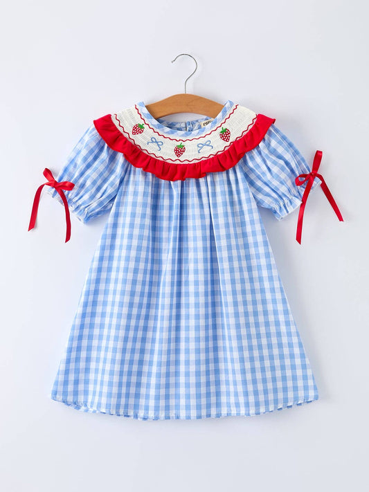 Blue checkered dress with red accents on a white background