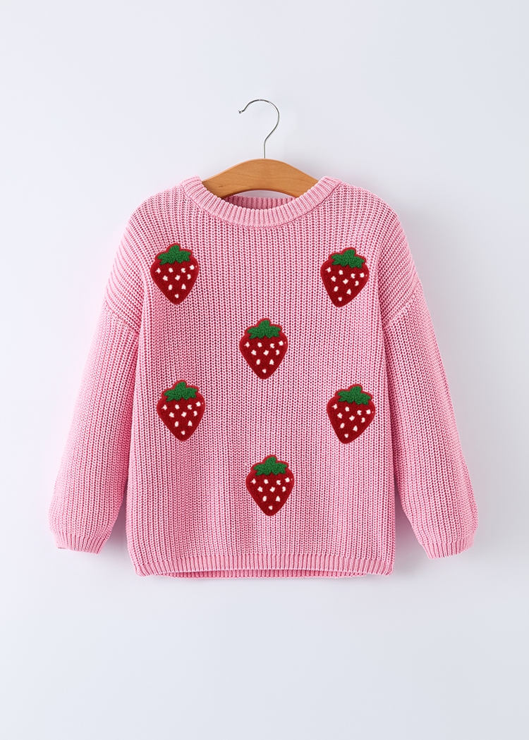 Pink sweater with strawberry patterns on a hanger against a white background