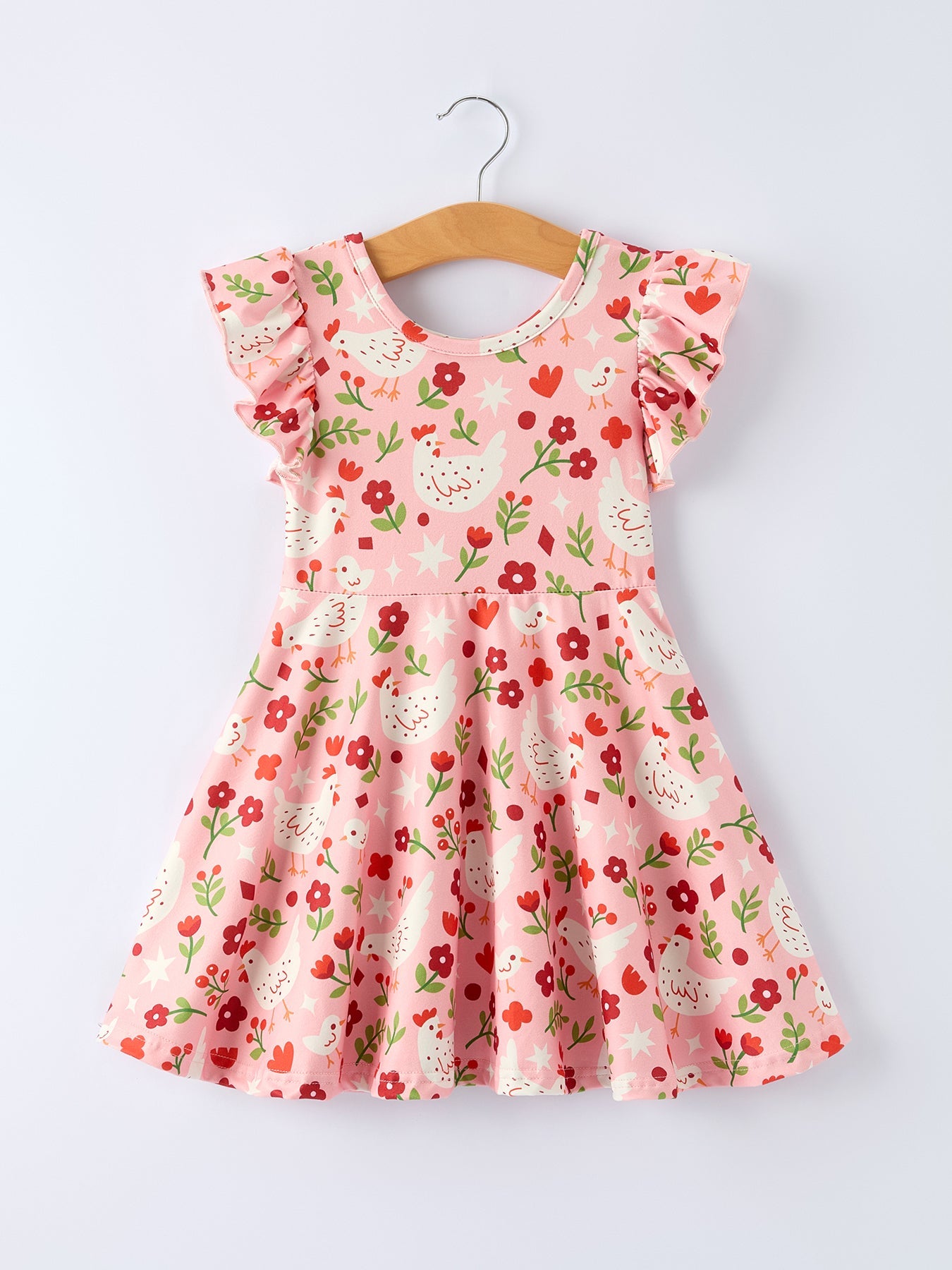 Pink floral dress on a wooden hanger against a white background