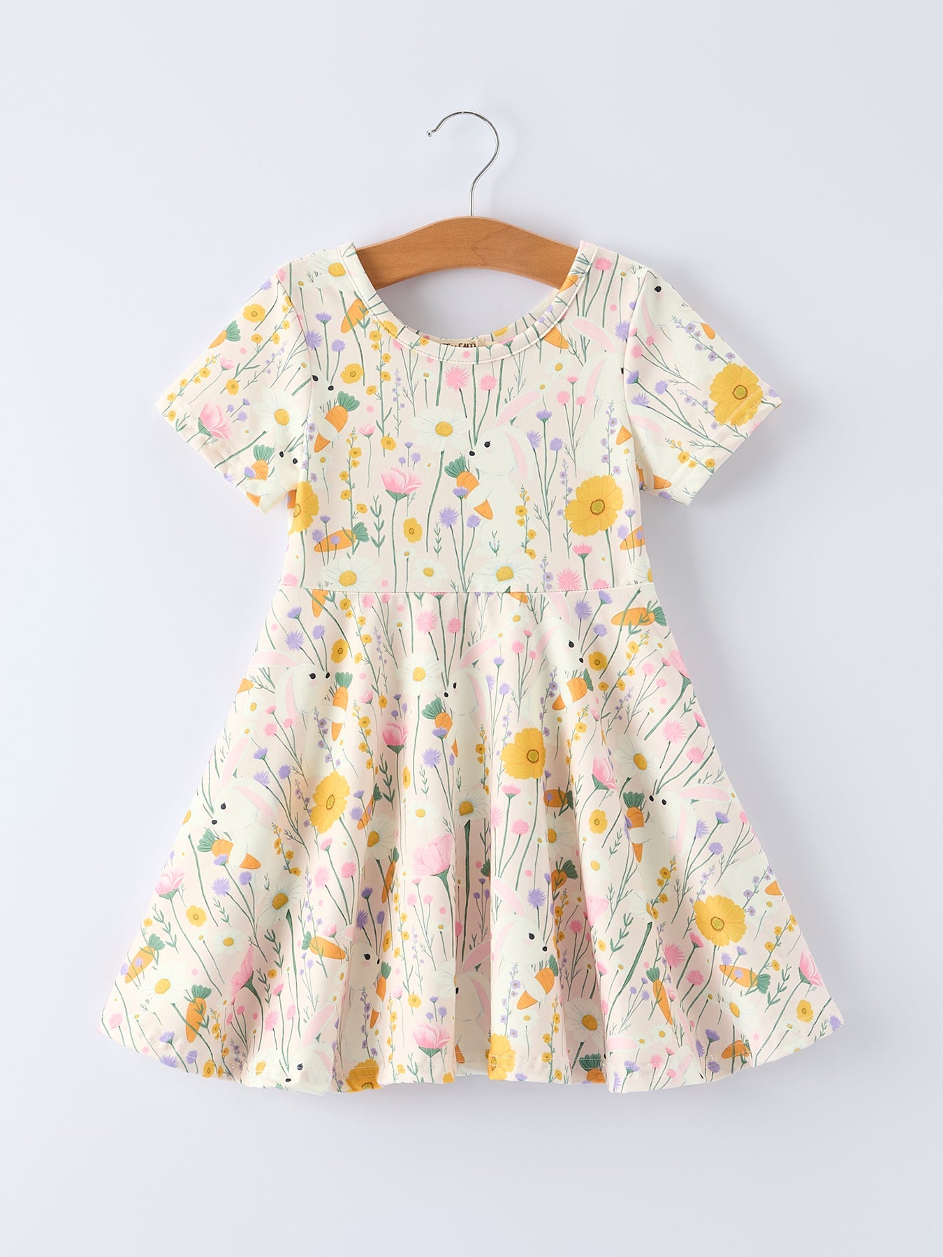 Floral dress on a hanger against a light gray background