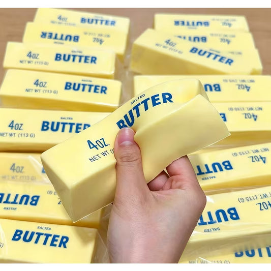 Squishy butter stick sensory fidget toy with realistic printed butter wrapper design, front view