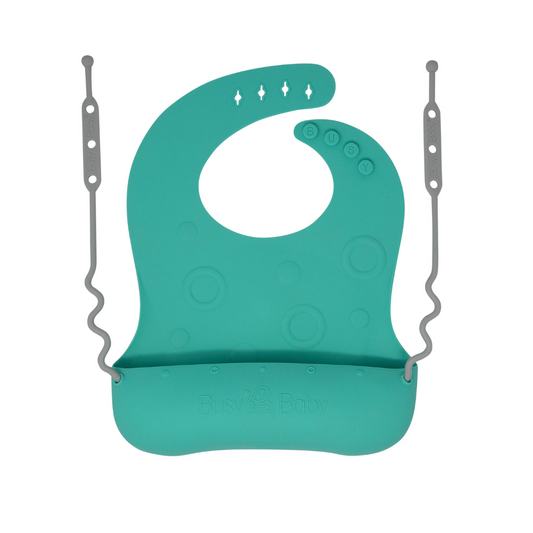 Spearmint silicone Travel Tether Bib with oversized pouch and utensil tethers for easy baby feeding and mess containment