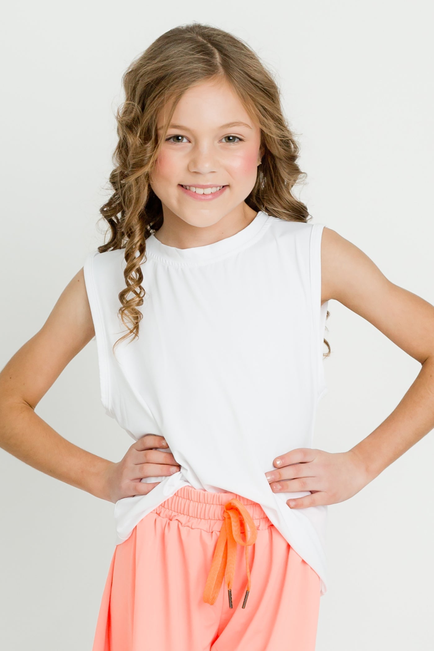 White high low kid top sleeveless athletic tank on smiling girl